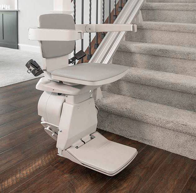 Stairlift Service with a chair at the base in Upper Marlboro