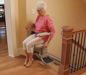 Hamar Stairlift Repair being rode by a woman in a red shirt in Fredrick 