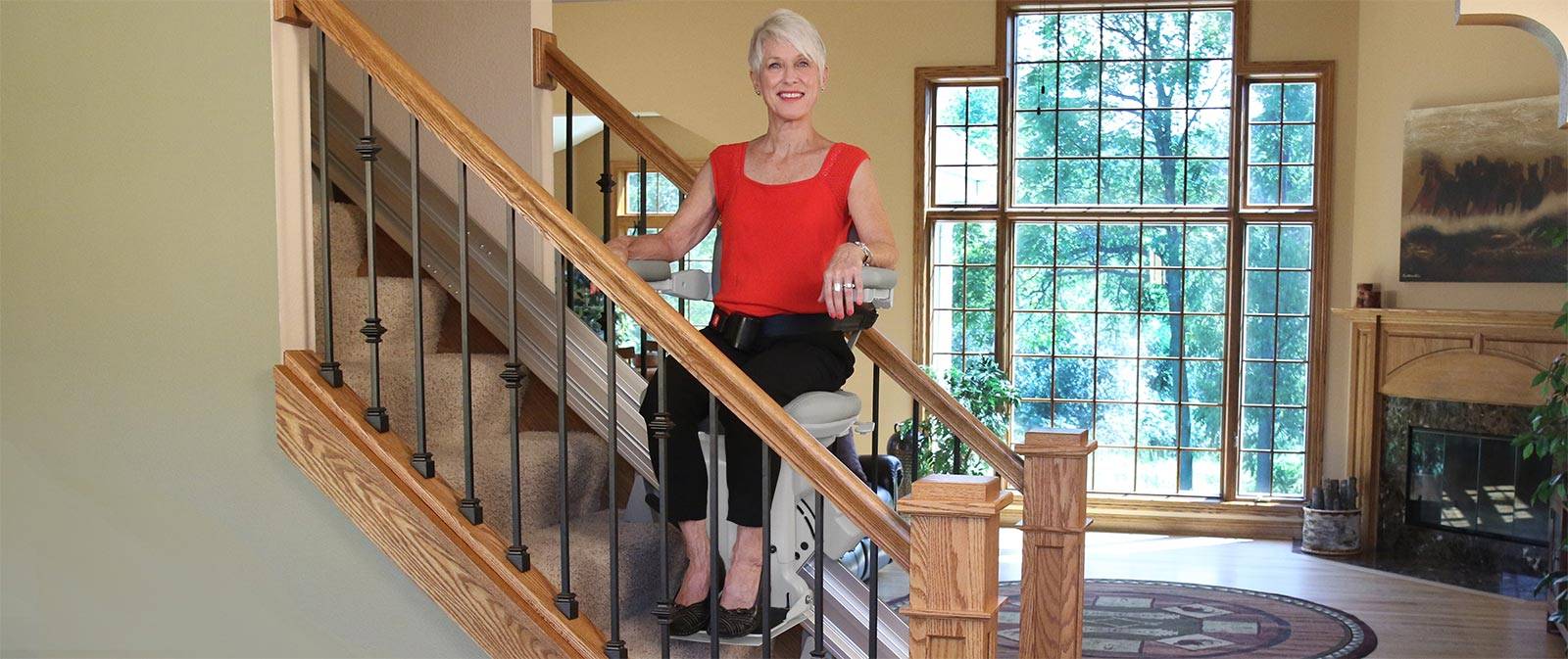 bruno-elite-stair-lift-straight-woman-on-stairs-hero-1600x673-1