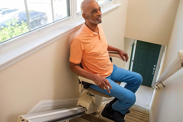 a man using a Stairlift after a Stairlift Installation in Wilmington, DE, Rockville, MD, Towson, MD, Dundalk, MD, Arlington, VA, Falls Church, VA