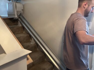A Stairlift Installation Being Completed by a Professional in a Alexandria, VA Home